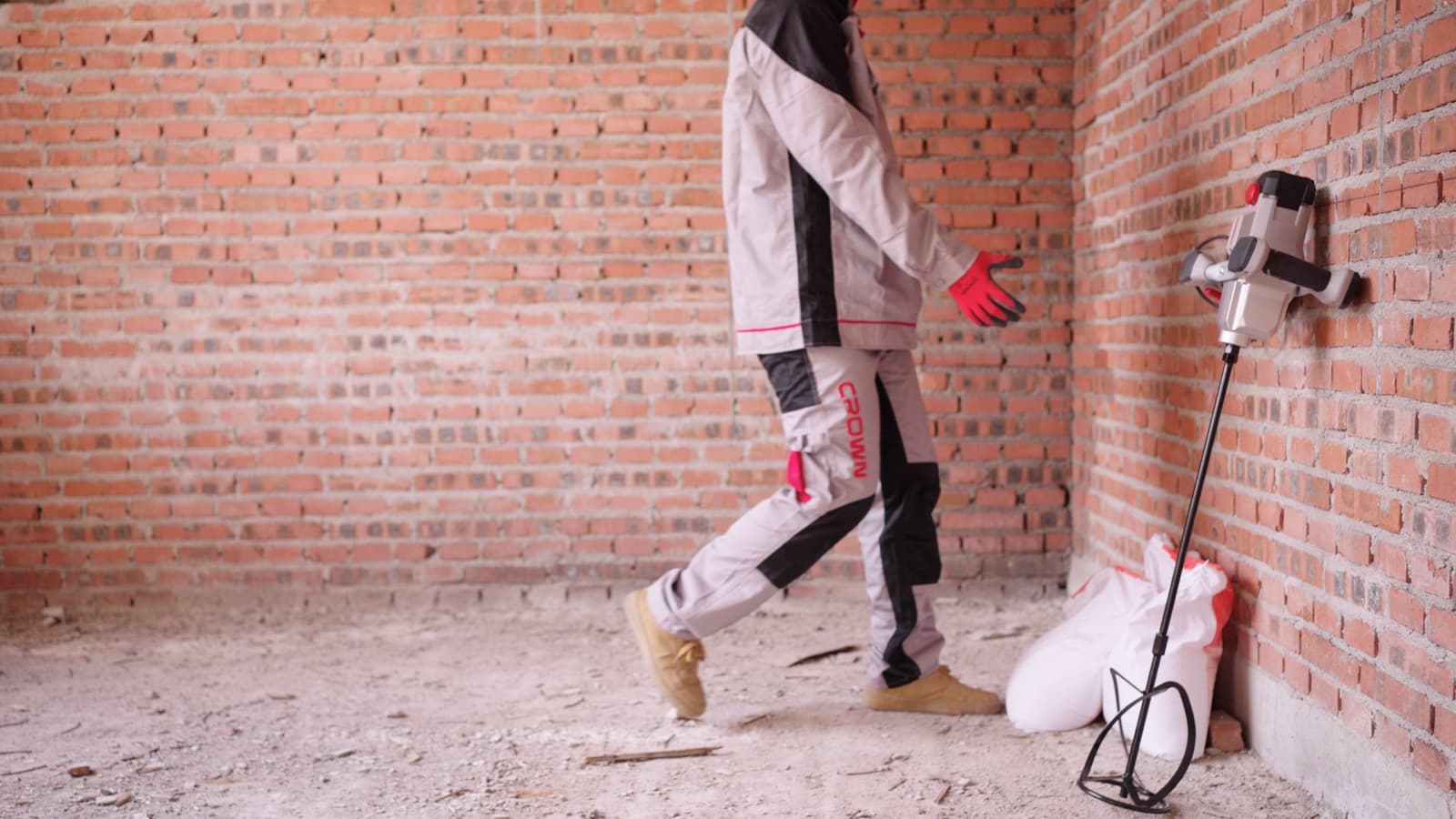 Crown mixer drill on construction site — mixing plaster